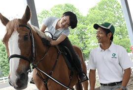 乗馬を楽しむ女性とインストラクター